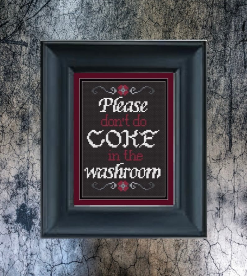 May include: A black framed sign with a red border and white text that reads "Please don't do coke in the washroom".