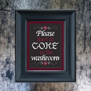 May include: A black framed sign with a red border and white text that reads "Please don't do coke in the washroom".
