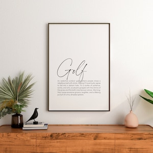 May include: A black and white printable wall art print with a definition of the word "Golf". The definition reads: "An addictive outdoor game where people chase a rebellious ball with sticks, hoping it'll eventually agree to fall into a distant hole. It's a battle of patience, sanity, and wits, as players grapple with the whims of the grass and the ball's mischievous nature. Warning: May cause excessive groans, laughter, and a lifelong pursuit of a tiny dimpled sphere."