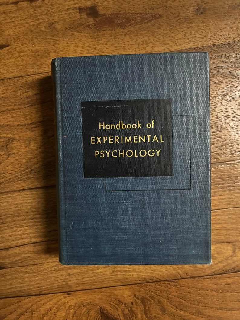 Puede incluir: Un libro de tapa dura azul con el t&iacute;tulo "Handbook of EXPERIMENTAL PSYCHOLOGY" impreso en letras doradas sobre un fondo negro.