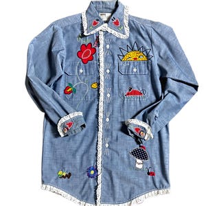 Montgomery Ward ~ Women’s Large ~ Vintage (1980’s) ~ Denim Blue W/ Multi-Colors Floral & Ladybug Patches ~ Button Up Shirt