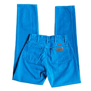 K&ouml;nnte beinhalten: Hellblaue Jeans mit klassischem F&uuml;nf-Taschen-Design. Die Jeans haben einen Wrangler-Markenaufn&auml;her auf der Ges&auml;&szlig;tasche und ein rotes Logo-Etikett. Die Jeans sind einfarbig und haben ein gerades Bein.