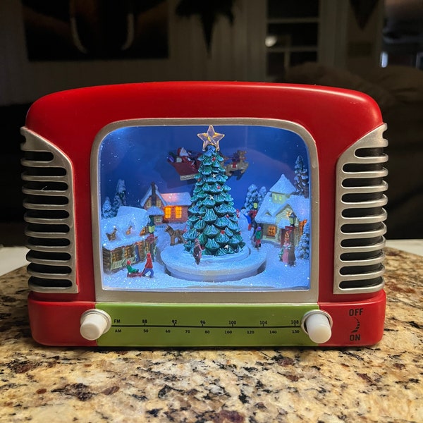 Roman, Inc. Christmas TV Plays Music W/ Rotating Scene