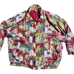 May include: A vintage red jacket with a full zipper and a collar. The jacket features a repeating pattern of beige, green, and yellow shapes and designs. The jacket has elastic cuffs and a hem.