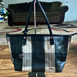 May include: Black and white plaid tote bag with a silver heart charm and the word "Usagi" in red lettering.