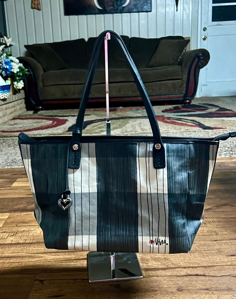 May include: Black and white plaid tote bag with a silver heart charm and the word "Usagi" in red lettering.