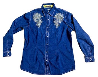 May include: A long-sleeved dark blue denim shirt featuring a button-down front, a collar with a lime green inner lining, and intricate silver-toned embroidery with small embellishments on the upper chest area on both sides of the placket.