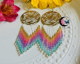 May include: A pair of gold rose-shaped earrings with a white, pink, purple, and blue beaded fringe.