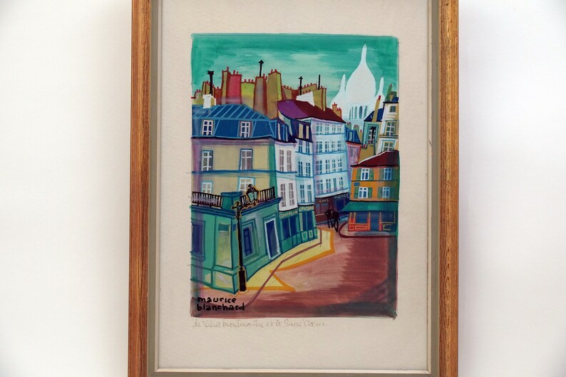 May include: A colorful painting of a Parisian street scene with buildings, a church, and a street lamp. The painting is signed "maurice blanchard" and titled "La Ville Perdue de Saint Germain".