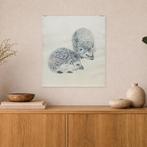 May include: A rectangular wall art print featuring a detailed graphite or charcoal drawing of two hedgehogs. One hedgehog is positioned slightly behind and above the other, both rendered in shades of gray against a light, neutral background.
