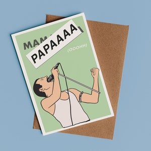 May include: A green and white greeting card with a cartoon illustration of a person singing into a microphone. The card has the text "Mama" and "Papaaa" written on it.