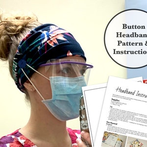 May include: A woman wearing a blue and pink floral headband with a button on the side. The headband is designed to hold a face mask in place. The woman is also wearing a clear face shield and a blue surgical mask. The image includes instructions for making a button headband.