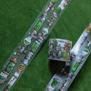 May include: Decorative washi tape featuring a steampunk-inspired design. The tape showcases detailed illustrations of pipes, gears, and glass containers filled with green liquid and foliage. The tape is on a green background.