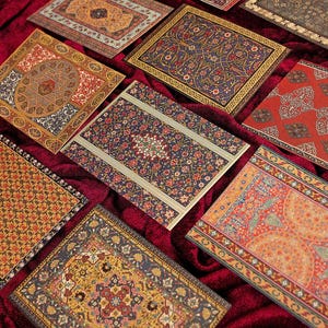 May include: A collection of rectangular cards featuring intricate, multi-colored patterns inspired by traditional rug designs. The cards display various motifs in shades of red, blue, gold, and black, arranged in a scattered layout.