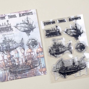 May include: Steampunk Travel Blueprints art print and clear stamps. The print features detailed illustrations of airships, a train, and mechanical designs. The clear stamps include the words "Steampunk Travel Blueprints".