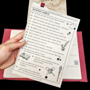 May include: A white page with black text and illustrations of a quill pen, a wax seal, and an open book. The text includes quotes from various authors, such as Marcus Aurelius, Confucius, and William Shakespeare. The page is part of a journal or notebook.