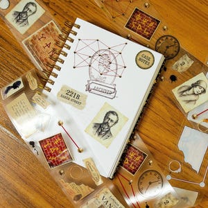 May include: A spiral-bound notebook with a white cover featuring a red geometric web, a footprint, and the text 221B BAKER STREET, CASE NOTES, and ARCHIVED. The notebook is surrounded by clear adhesive tape strips decorated with vintage portraits, brick walls, clocks, and newspaper clippings.