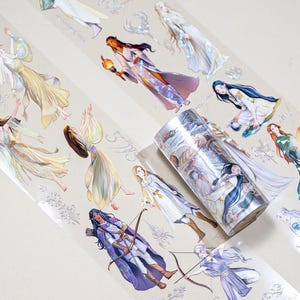 May include: A roll of decorative washi tape featuring illustrations of women in various poses and outfits. The tape has a silver holographic background with a subtle sparkle effect.