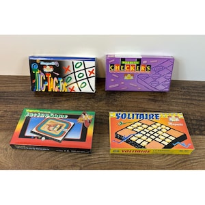 May include: Four rectangular game boxes featuring Magnetic Tic-Tac-Toe with a grid, Magnetic Checkers in purple, a Magnetic Racing Game with a colorful track, and a Magnetic Solitaire set with a grid and circular pieces, all displayed together.