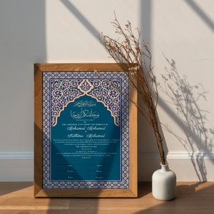 May include: A framed Islamic marriage certificate with intricate blue and gold floral designs. The text reads "This agreement is to certify the marriage of Mohamed Mohamed to Fathima Mohamed".