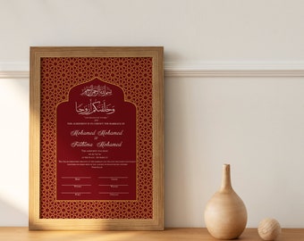 May include: A framed red and gold Islamic wedding certificate with Arabic calligraphy and the text "This agreement is to certify the marriage of Mohamed Mohamed and Fathima Mohamed".