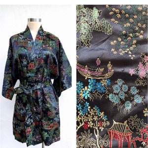 May include: A black silk robe with a floral and pagoda print in shades of blue, green, red, and gold. The robe has a sash tie and long sleeves.