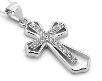 May include: A silver cross pendant necklace with clear cubic zirconia stones. The cross is double layered and has a delicate design.