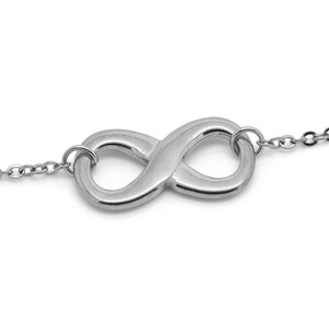 May include: A silver infinity symbol pendant necklace with a delicate chain.