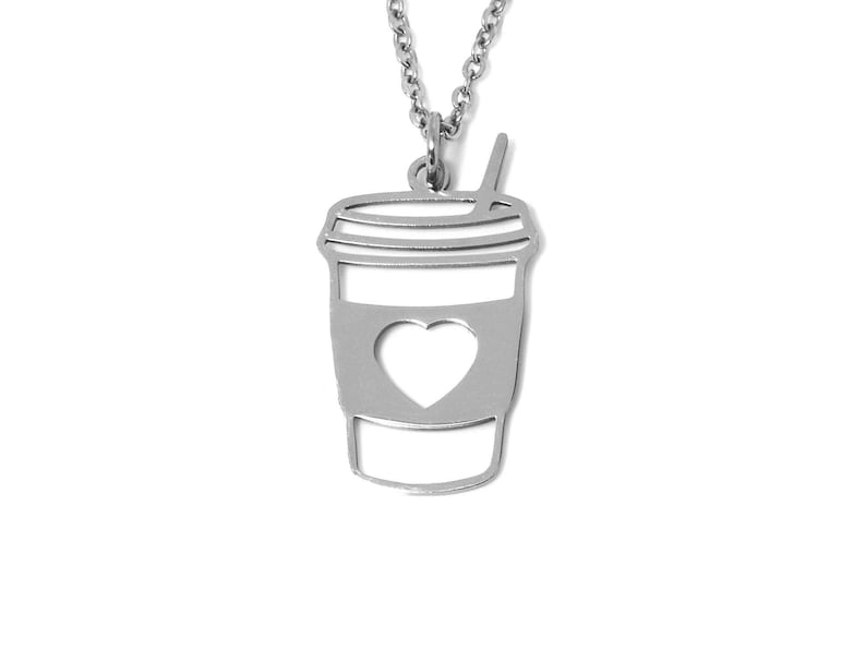 May include: Silver necklace with a coffee cup pendant featuring a heart cutout.