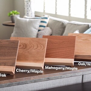 May include: Four wooden display stands with different wood grain patterns. The stands are labelled "Walnut/Oak", "Cherry/Maple", "Mahogany/Maple", and "Oak/Walnut".