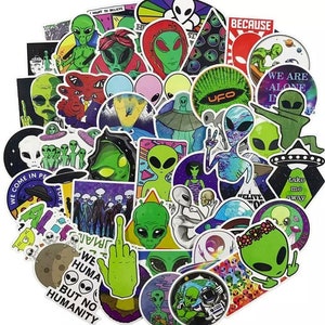May include: A set of 50 colourful alien themed stickers. The stickers feature various alien designs, including green aliens with large eyes, UFOs, and phrases like "We are alone in peace" and "Take me away".