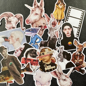 May include: A collection of colourful stickers featuring various illustrations, including animals, people, and abstract designs. The stickers are printed on white paper with a glossy finish.