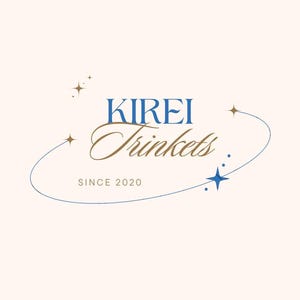 May include: Logo for "KIREI Trinkets" in blue and brown script, with a blue curved line and star accents. The text "SINCE 2020" is below the main text. The background is a light beige color.