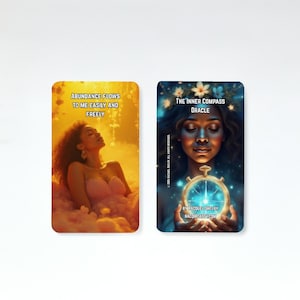 May include: Two oracle cards. One card has a woman in a pink dress with the text "ABUNDANCE FLOWS TO ME EASILY AND FREELY". The other card has a woman holding a compass with the text "THE INNER COMPASS ORACLE".