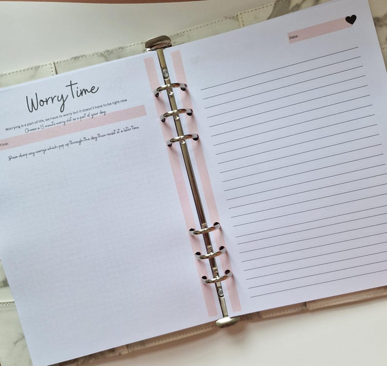 May include: A pink and white planner with a section labeled "Worry Time". The text reads "Worrying is a part of life, we have to worry but it doesn't have to be right now.  Down a 15 minute worry slot as part of your day.  Write down any worries which pop up throughout the day then revisit at a later time."