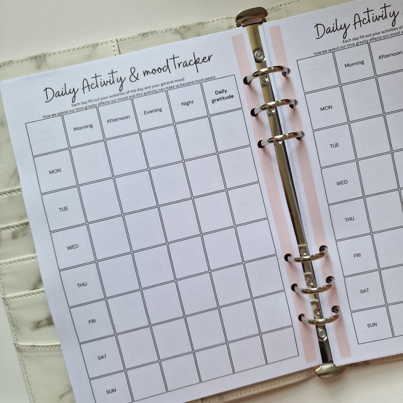 May include: A printable daily activity and mood tracker with sections for morning, afternoon, evening, night, and daily gratitude. The tracker is designed for a week, with each day of the week listed on the right side of the page.