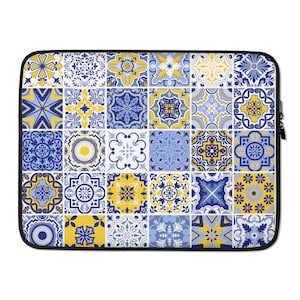May include: A laptop sleeve featuring a blue and yellow geometric pattern. The pattern is made up of repeating squares with different designs. The sleeve is made of a soft, durable material and is ideal for protecting your laptop.