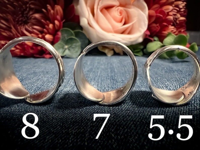 May include: Three silver rings of different sizes, laid out on a blue denim background. The rings are labeled with their sizes: 8, 7, and 5.5.