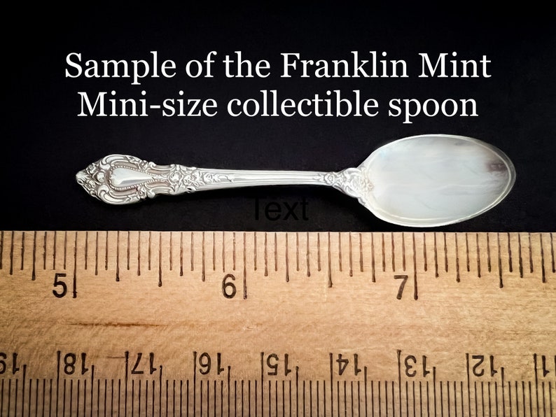 May include: A silver spoon with an ornate handle, measuring approximately 6.5 inches long. The spoon is labeled "Sample of the Franklin Mint Mini-size collectible spoon".