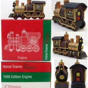 May include: A decorative miniature train engine with brown, gold, and black accents. The engine is part of the "Home Towne Express" 1998 Edition. The engine is displayed with its original red, green, and white box.