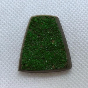 Natural Uvarovite (Green Garnet) cabochon with crystals on top from Ural Mountain, Russia. Crystals are on Chromite matrix.