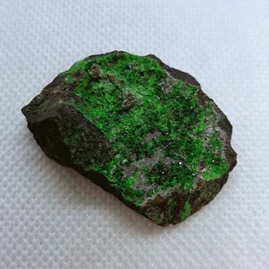 Natural Uvarovite (Green Garnet) crystals on Chromite matrix from Ural Mountain, Russia.