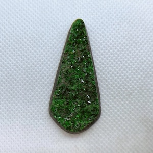 Natural Uvarovite (Green Garnet) cabochon with crystals on top from Ural Mountain, Russia. Crystals are on Chromite matrix.