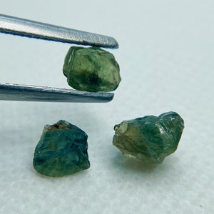 Set of bicolor (blue-green-yellow) unheated untreated sapphire gem rough crystals.