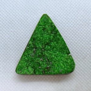 Natural Uvarovite (Green Garnet) cabochon with crystals on top from Ural Mountain, Russia. Crystals are on Chromite matrix.