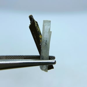 Natural Goshenite (white beryl) with black tourmaline (schorl) crystal from Namibia.