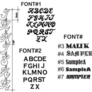 May include: A black and white image showcasing various font styles for personalized jewelry. The image includes a sample name pendant that is 7.60 inches long and 1 inch wide. Several font options are displayed, including cursive and block letters, with the text "FONT#" and sample names.