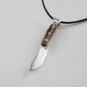 Nessmuk knife pendant made of silver. Replica of the historical nessmuk knife. Jewellery of forged bladed weapons. Handmade jewelry