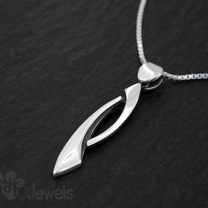 Elegant pendant made of silver with a polished finish and details in aged silver. Silver pendant. Handcrafted jewel