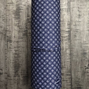 May include: A rolled up blue fabric with a white circle pattern. The fabric has the word "Shippou" printed on it and the word "nekki" printed on the bottom.